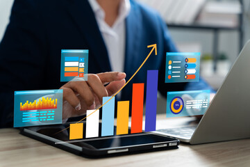 Businessman analyzing data on tablet with hologram dashboard graphs. Futuristic interface represents business growth, Financial performance, Strategic marketing, Planning advanced data analytics.