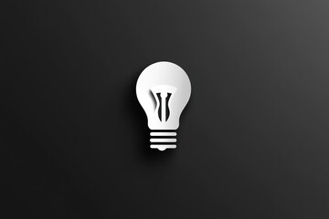 A bright white lightbulb icon casts a soft shadow against a dark background
