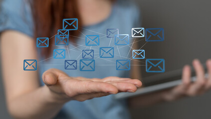 Image depicts a network of email icons above a woman's hand, symbolizing email marketing or...