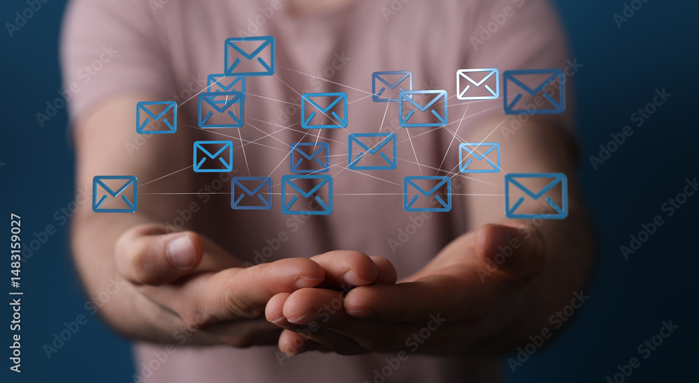 Poster person holding interconnected email icons, symbolizing global communication and networking.