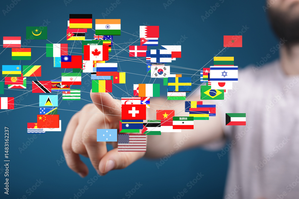 Fototapete hand interacting with a digital display of world flags, symbolizing global connectivity and internat