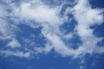 Blue sky with fluffy clouds.