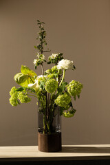 Elegant vase with fresh flowers bouquet on table