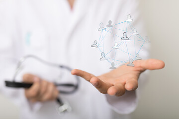 Image of a doctor's hand displaying a network representing patient care and connection.