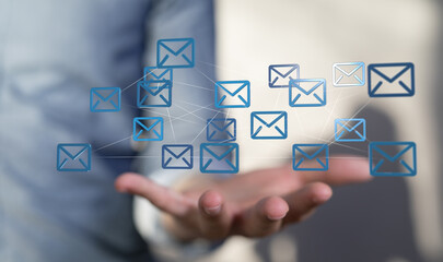 Hand holding network of email icons. Digital communication concept.