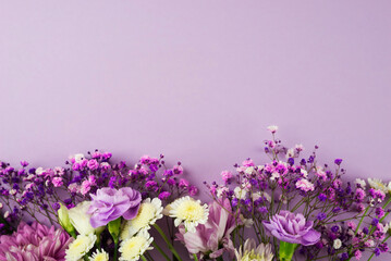 Creative layout of purple flowers composition on purple background. Flat lay with copy space.