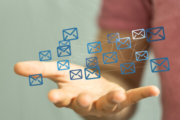 Hand holding network of email icons. Digital communication, connection, global network concept.