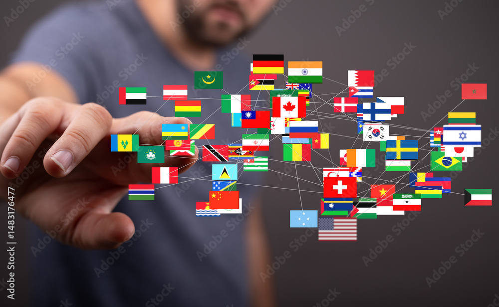 Leinwandbilder Image of a hand interacting with a network of interconnected world flags, symbolizing global connectivity.