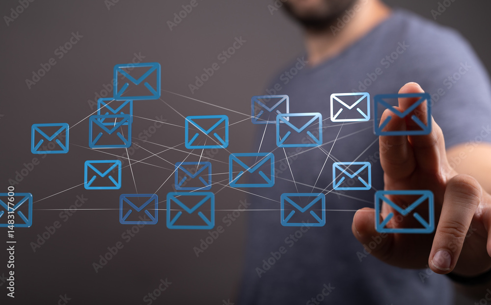 Poster Image of a man interacting with a digital network of email icons, representing global communication and interconnectedness.
