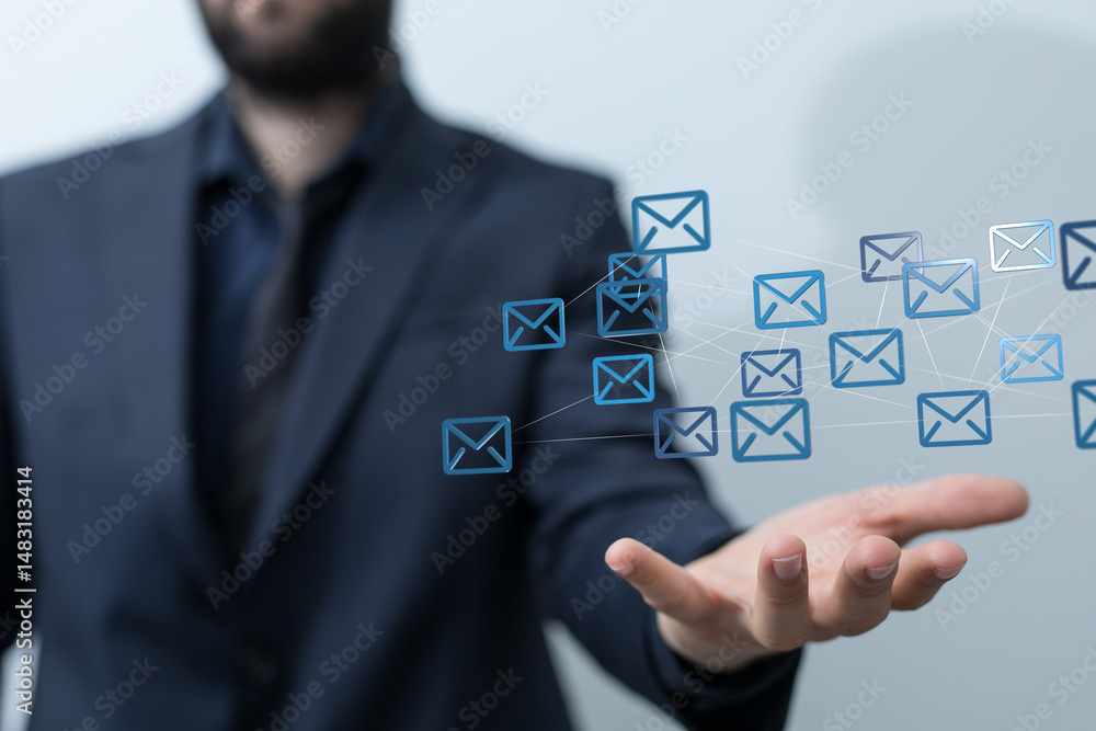 Poster Image of a businessman's hand with many email icons representing network communication.