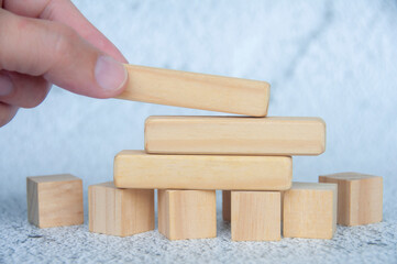 Hand placing wooden blocks with customizable space for text or ideas. Copy space concept