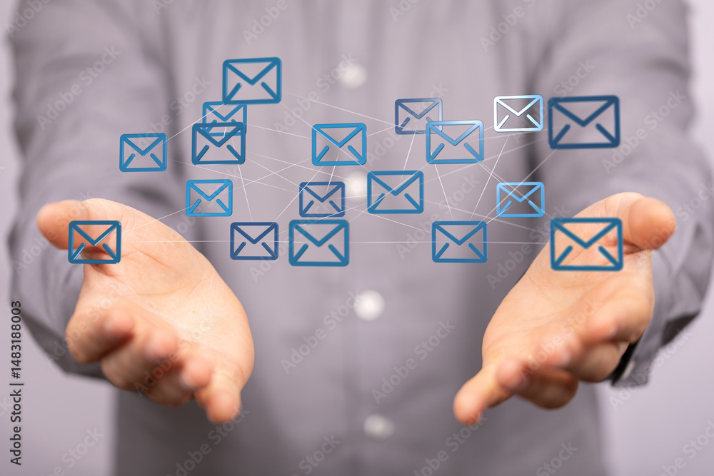 Poster person's hands presenting a network of email icons, symbolizing global communication and interconnec