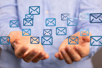 Hands holding digital email icons, representing global communication and networking.
