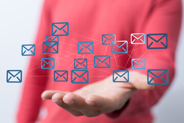 Hand holding network of email icons.  Digital communication, global connection, and networking concept.
