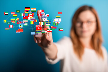 Image of a woman connecting with a global network of flags, representing international business or...