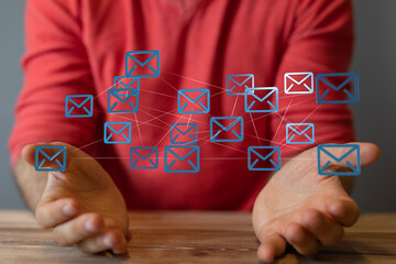 Person interacting with a network of email icons, illustrating communication and connectivity.