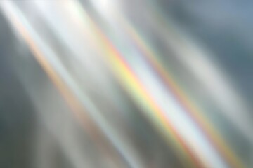 Abstract background featuring diagonal light beams with subtle rainbow spectrum colors