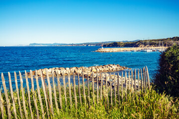 Seascape with wooden fence on a cloudy day. Coudouliere Beach (Six-Fours-les-Plages), France Europe