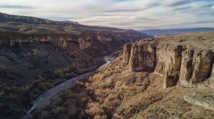 Obraz premium High-angle view of a valley with a river and dramatic cliffs.