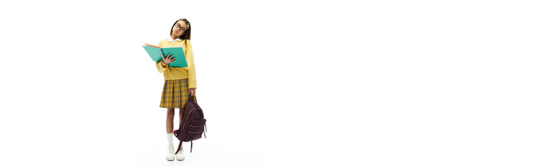 Stylish Asian schoolgirl poses confidently in a bright studio filled with vibrant energy