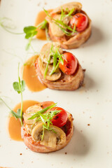 Gourmet dish featuring stuffed meat rolls with vegetables and sauce on a white plate