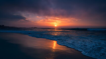 Dramatic Ocean Sunset: Vibrant Orange and Purple Hues Paint the Sky as the Sun Dips Below the Horizon.