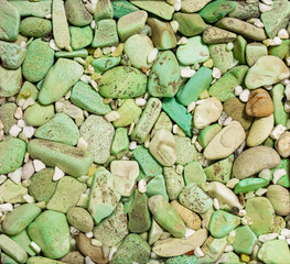 Top view of the nature green tone stones are arranged and decorated with small pebbles as a background textures