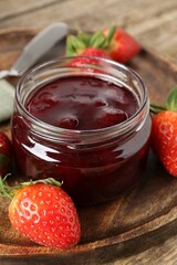 Delicious strawberry sauce and fresh berries on wooden table, closeup