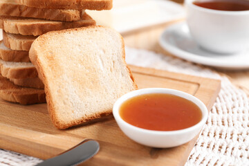 Slices of tasty toasted bread and jam on table, closeup