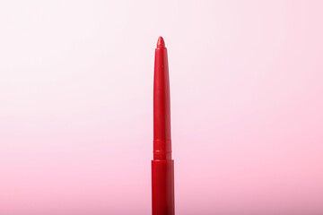 One twist up eye pencil on pink background, closeup