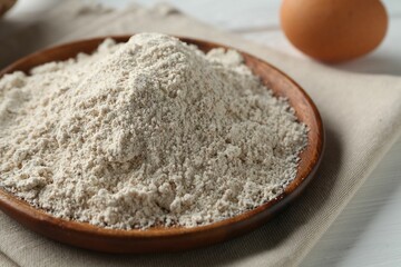 Pile of flour and egg on table, closeup