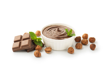 Tasty chocolate spread with mint in bowl and hazelnuts isolated on white