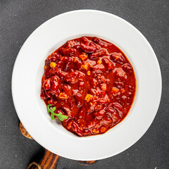 Chile con carne dish plate bean, tomato, corn, meat fresh gourmet food background on the table rustic food top view copy space
