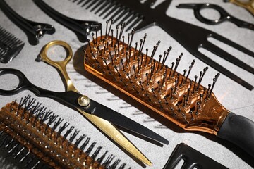 Different hairdresser's tools on grey table, closeup