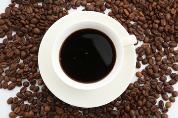 Aromatic coffee in cup and beans on white background, flat lay