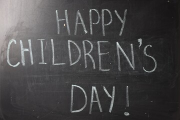 Fototapeta premium Phrase Happy Children’s Day with exclamation mark on blackboard