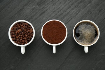 Aromatic ground coffee, beans and hot drink on black table, flat lay