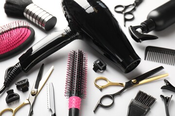Different hairdresser's tools on light grey background