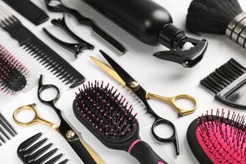 Different hairdresser's tools on light grey background