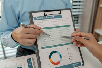 the company's auditing staff is checking the documents for accuracy in the office, businessman is...