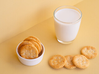 Biscuits cracker homemade and glass of milk on beige background. Minimalist product, Breakfast