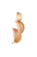 Side view of three unpeeled garlic cloves or pieces in stack isolated with clipping path in png file forma