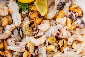 Seafood bowl shrimp, prawn, rapan, squid dish fresh gourmet food background on the table rustic food top view copy space keto  paleo diet vegetarian pescetarian diet