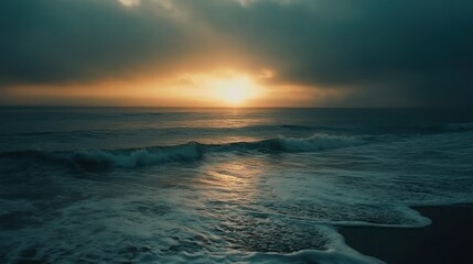 Dramatic ocean sunset with foamy waves and dark clouds enhancing the atmosphere