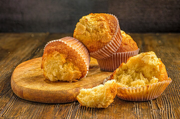 Freshly baked muffins on wood