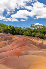 Vertical photo of Seven Coloured Earths of Chamarel, Mauritius: A Natural Volcanic Wonder.Vibrant Sand Dunes at Chamarel's Seven Coloured Earths, Mauritius Landscape.