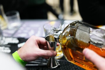 Pouring a fine spirit at a lively gathering during late evening festivities