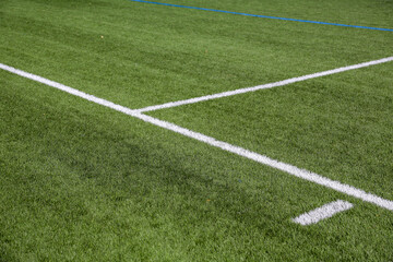 Obraz premium Artificial turf soccer field where we can see the goals, the corner with its flag, and the white lines.