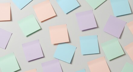 Pastel Colored Sticky Notes Scattered on a Light Gray Surface A Flat Lay Photography