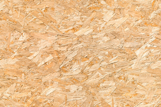 OSB Oriented strand board seamless background texture &ndash; pattern of flat fibreboard building panel from wooden chip material used in DIY, domestic and commercial construction.